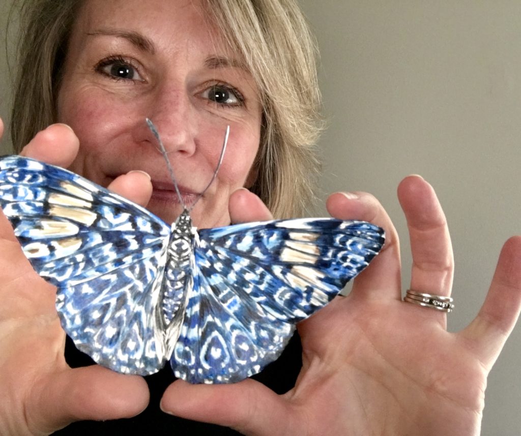woman holding butterfly art