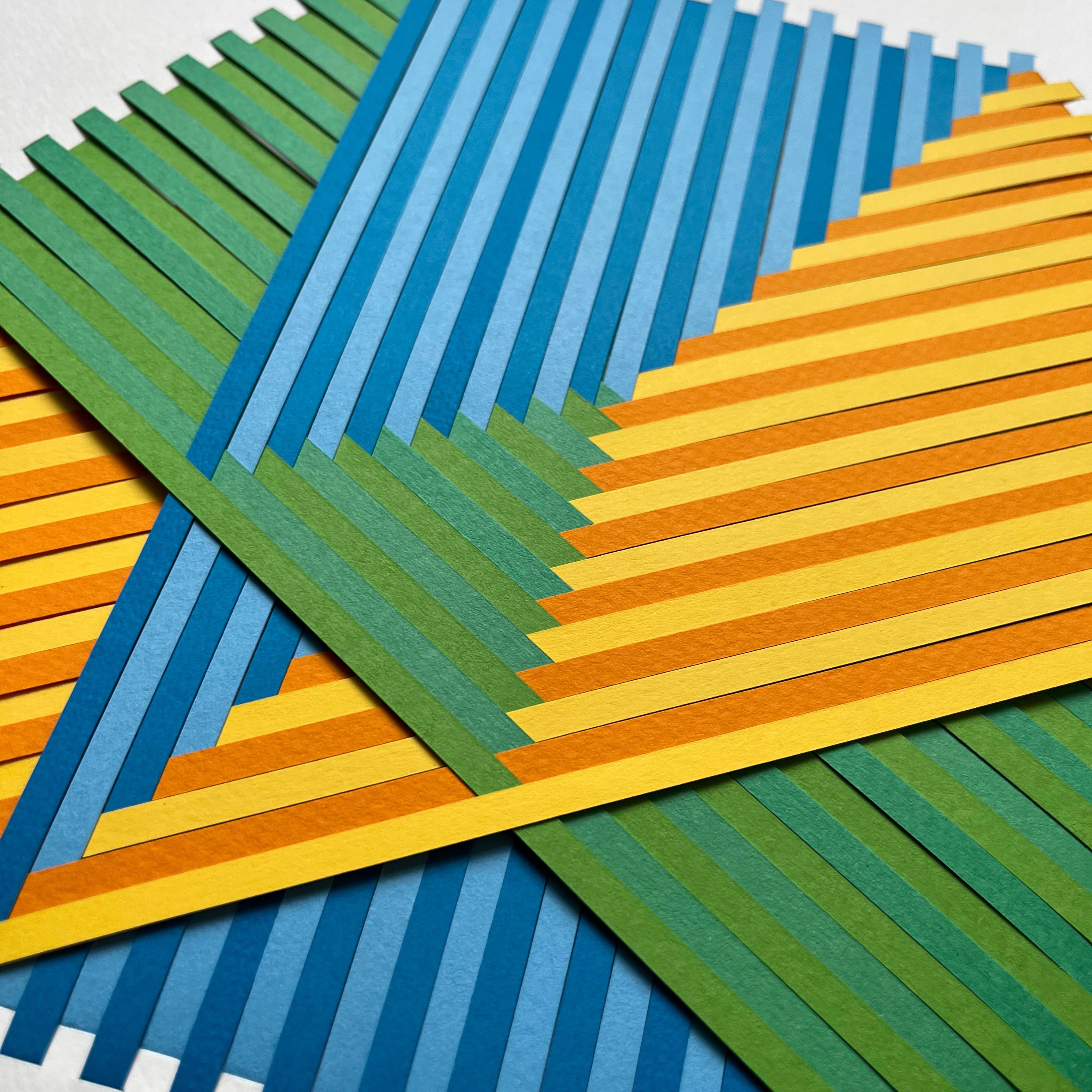 yellow, green, and blue paper strips, layered into a hexagonal shape