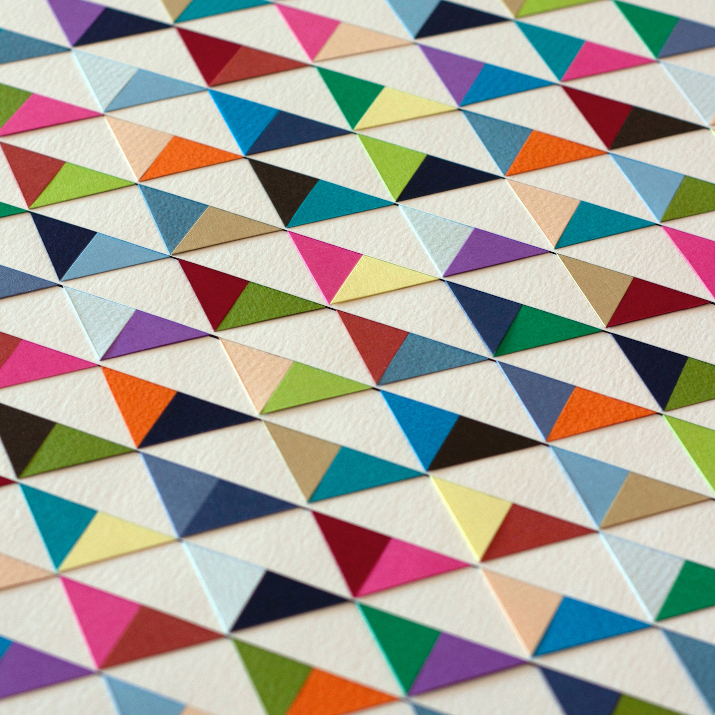 image of paper artwork featuring multicolored triangular shapes