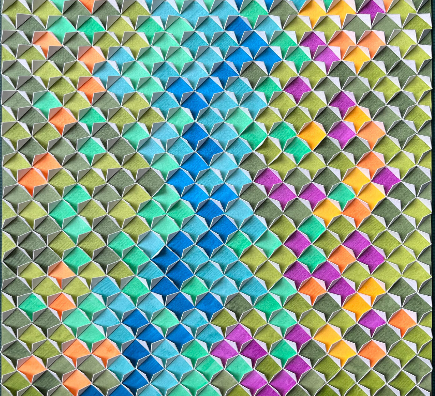 paper artwork consisting of painted paper squares in a grey, orange, blue, pink, and green pattern