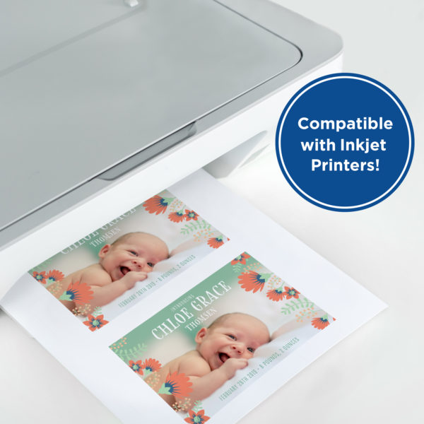 printer with page coming out. Page has two photos of an infant on it.