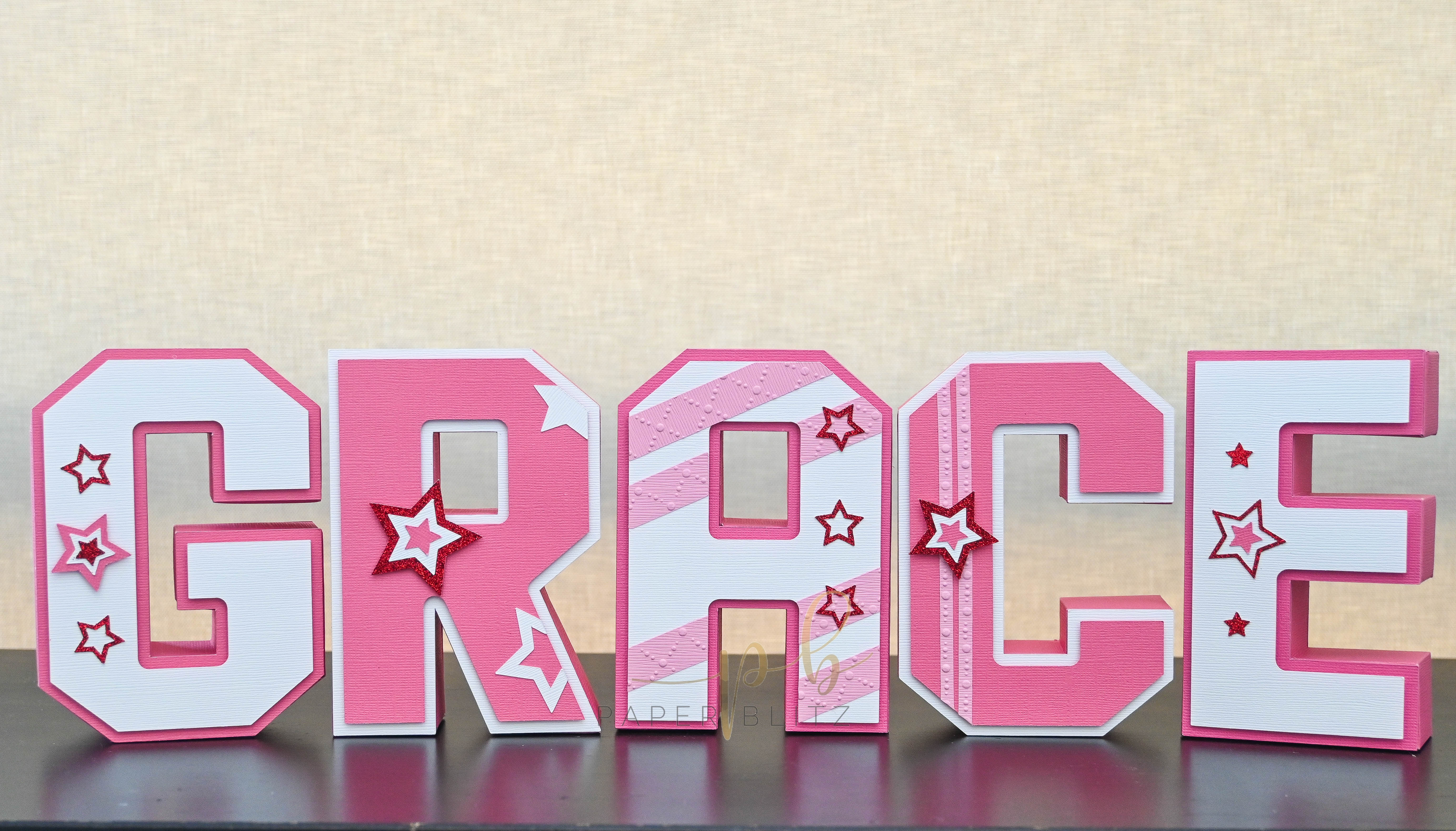 3d paper letters spelling the name 'GRACE'