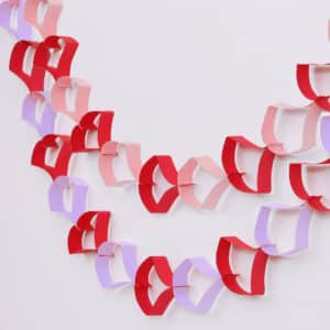 Free downloadable template to craft Valentine's Day Garland made of paper hearts stapled toghether